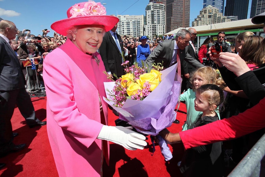 The Queen accepts flowers from well-wishers in Melbourne's Federation Square.