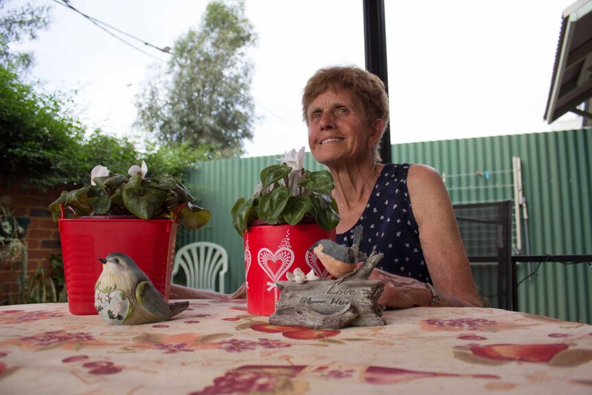 Marie French sits in her back garden at the Jack Tinetti Cottages in South Kalgoorlie.