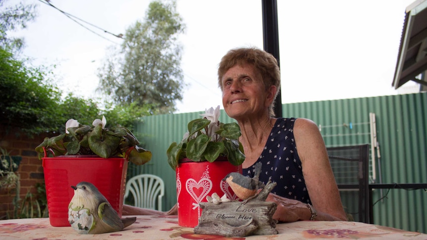 Marie French sits in her back garden at the Jack Tinetti Cottages in South Kalgoorlie.