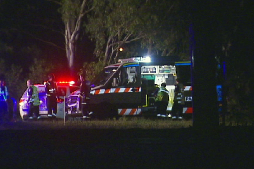 A team of paramedics gathers at the scene of an accident on the Western Freeway.