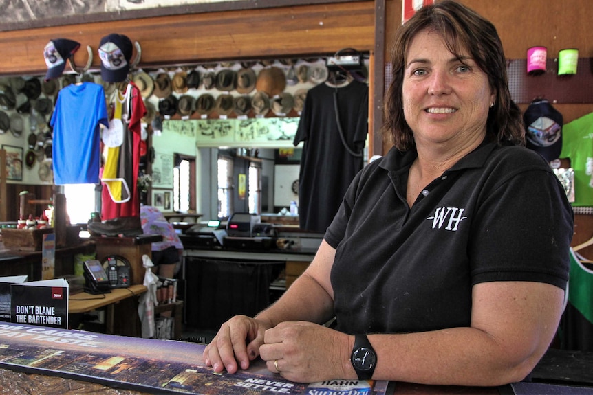 Wellshot Hotel owner Tracy Hatch leaning on the bar.