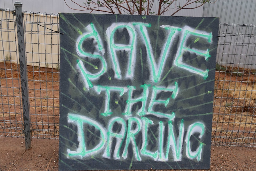 A handwritten sign reads "save the darling"