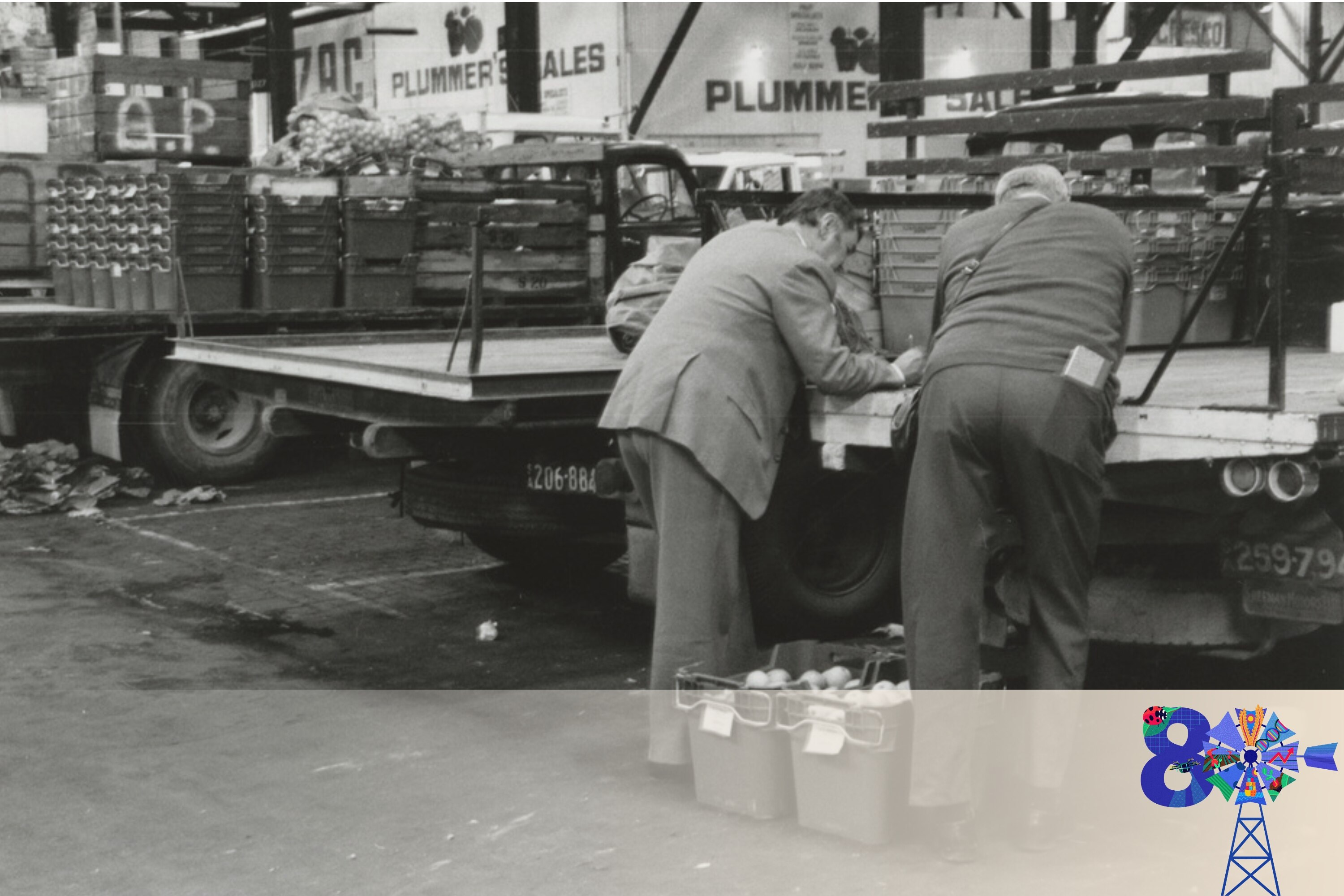 looking at two men at the back of trucks at fruit markets loading bay 