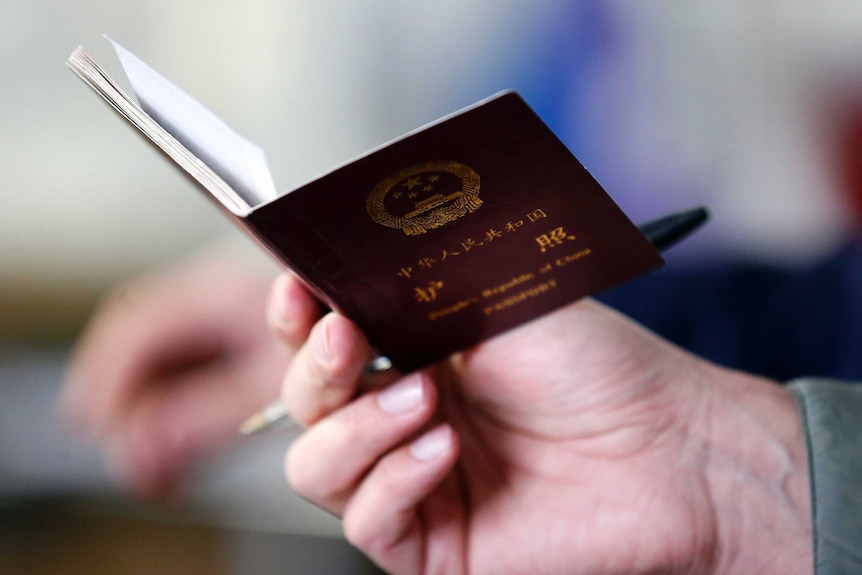 A police officer checks the passport of a Chinese immigrant at the Shen Wu textile factory in Prato December 9, 2013.