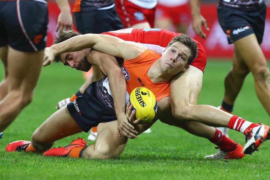 The Giants' Toby Greene is tackled by Sydney's Nick Smith at Sydney Showgrounds on June 12, 2016.