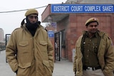 Police stand outside the Saket District Court in New Delhi