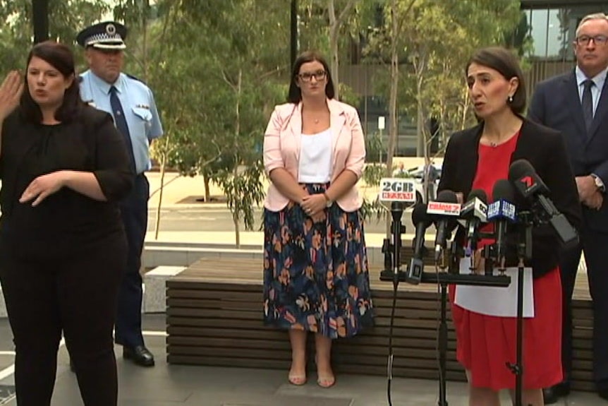 NSW Premier Gladys Berejiklian speaks at a microphone during a press conference