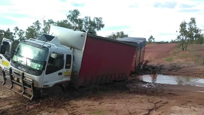 A truck bogged in mud.