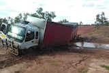 A truck bogged in mud.