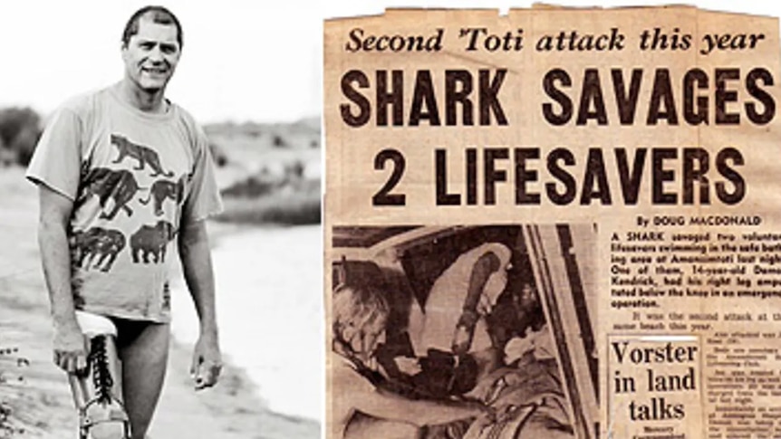 Man standing in swimmers with lower right leg amputated and old newspaper article about shark attack