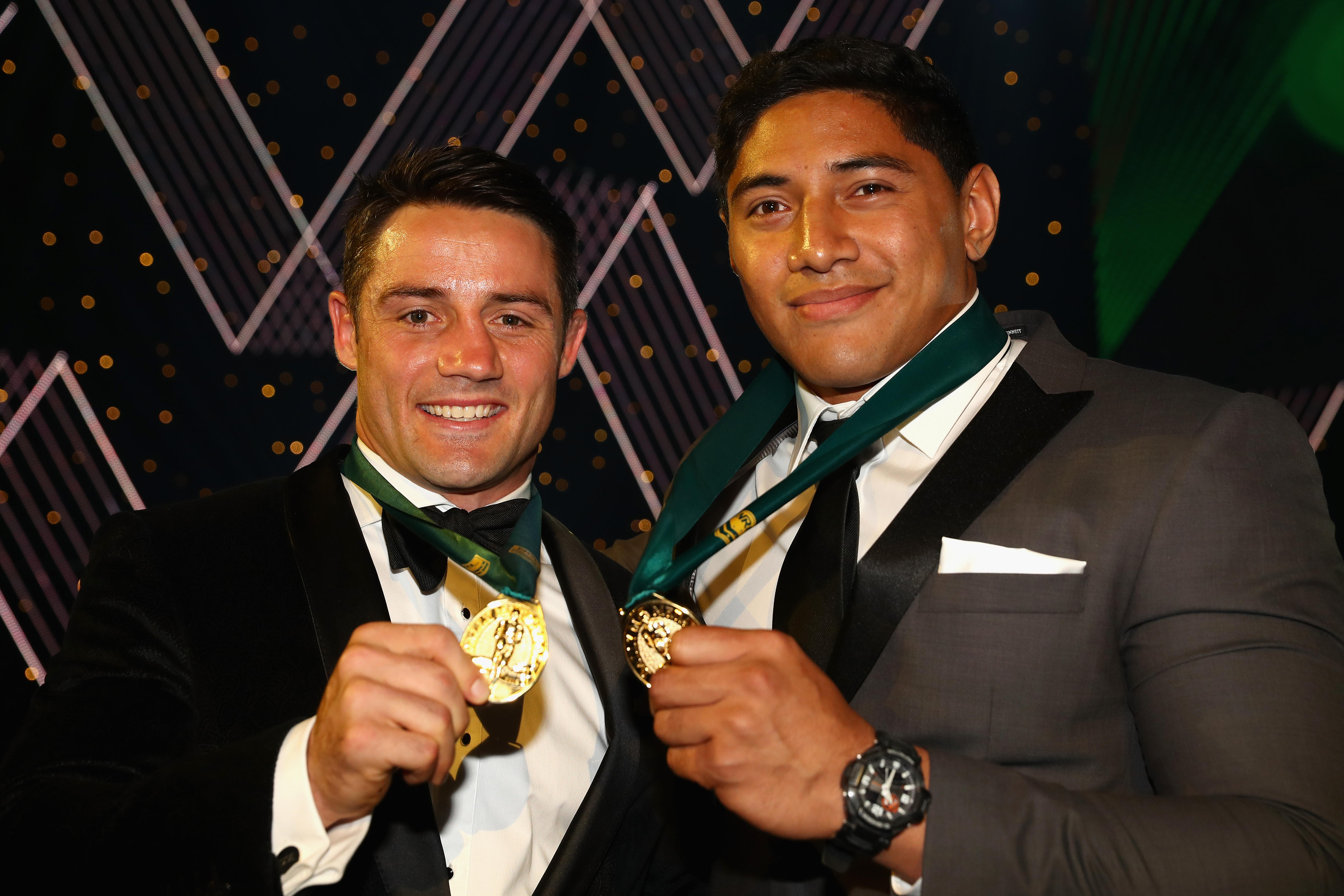 Cooper Cronk and Jason Taumalolo hold up their Dally M medals.
