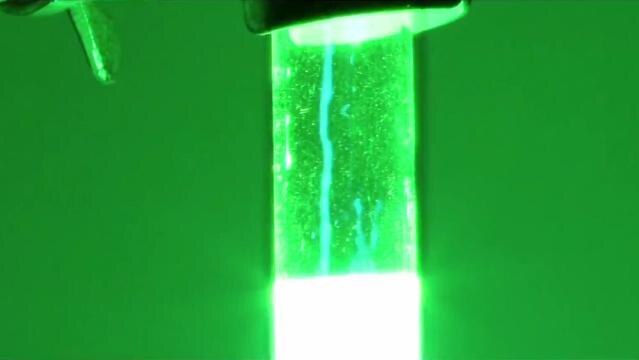 A glass tube glows brightly