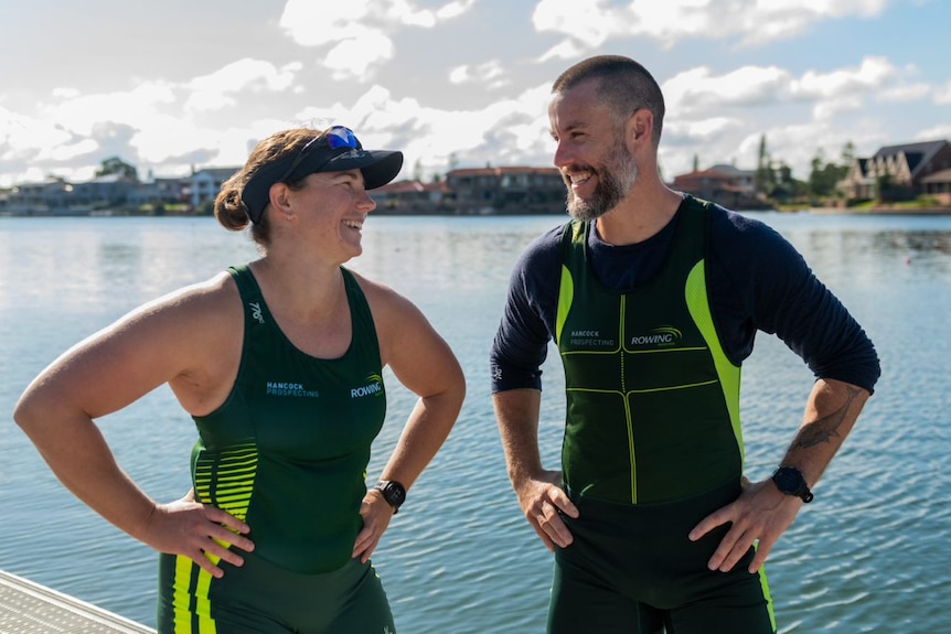 Two rowers with their hands on their hips.