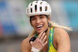 Madison de Rozario smiles as she crosses the line in the T53/54 Commonwealth Games marathon.
