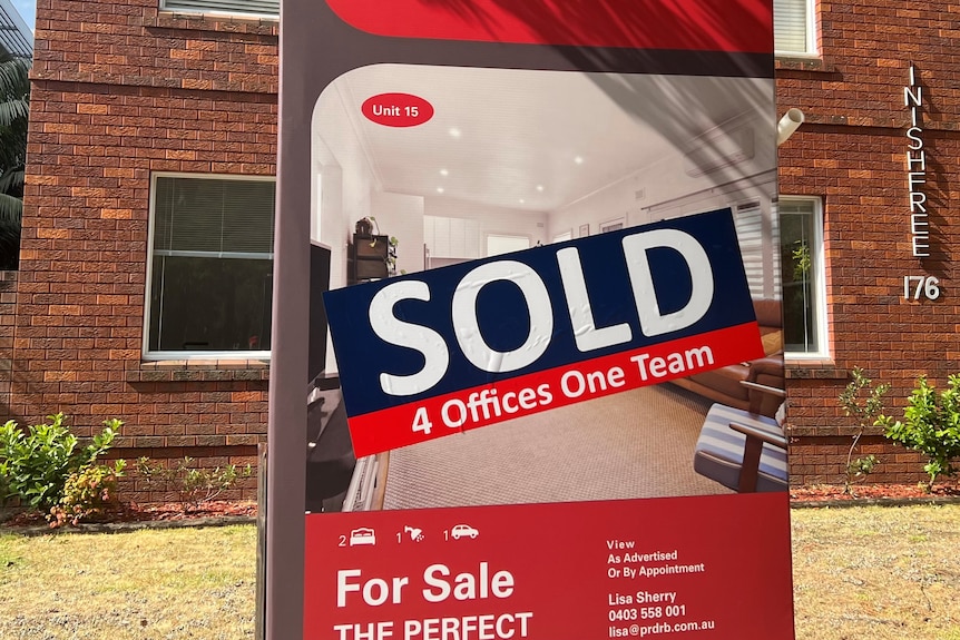 A sold sign out the front of an older red brick apartment block in Sydney's south.