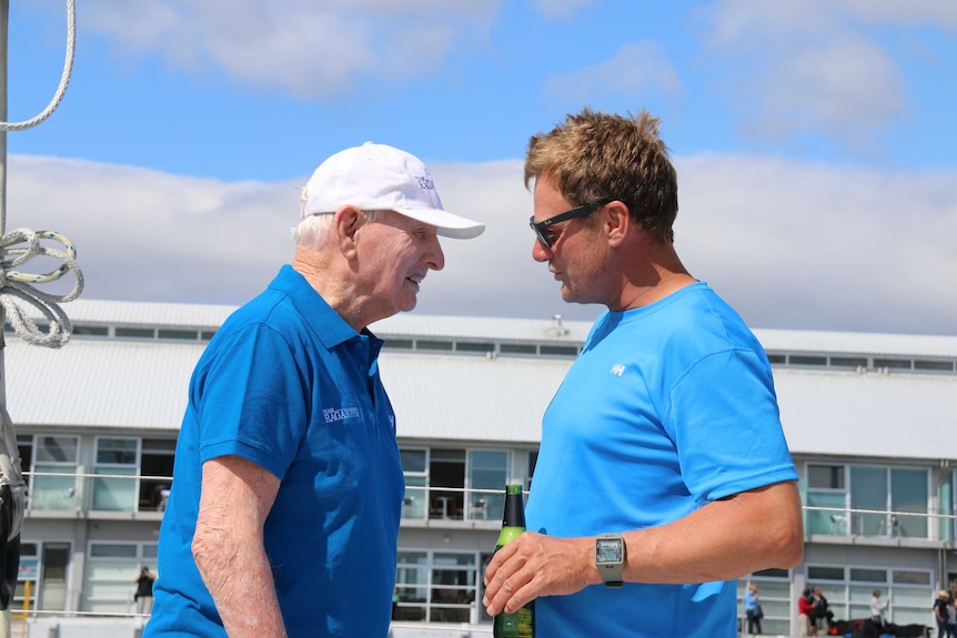 Syd Fischer talks with crew member