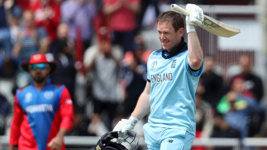 A cricketer raises his bat to celebrate a century at the Cricket World Cup.