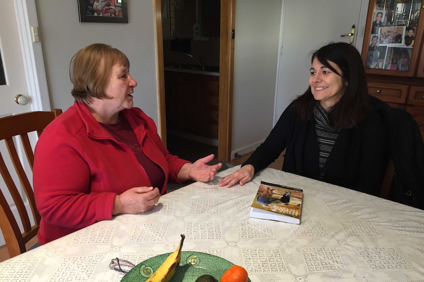 Giueseppina Colarusso sitting at a dining room table speaking to Dr Daniela Cosmini-Rose