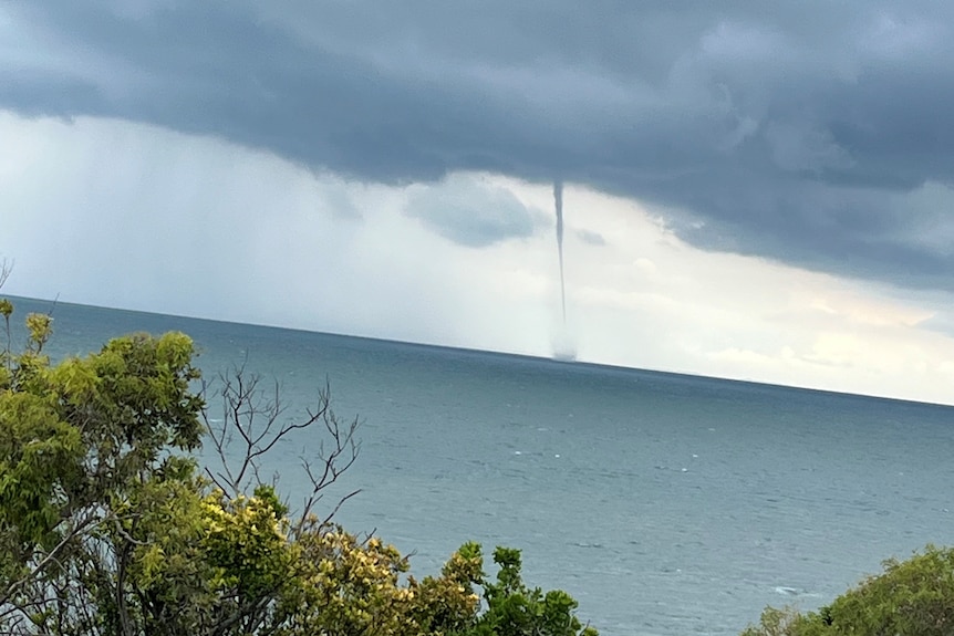 A waterspout over the ocean.
