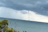 A waterspout over the ocean.