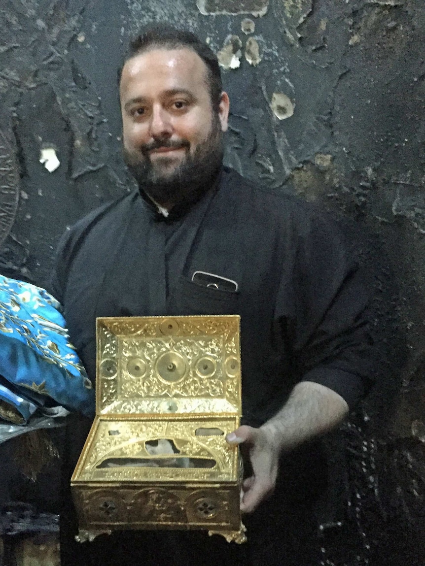 Father Michael Pfaromatis with relics