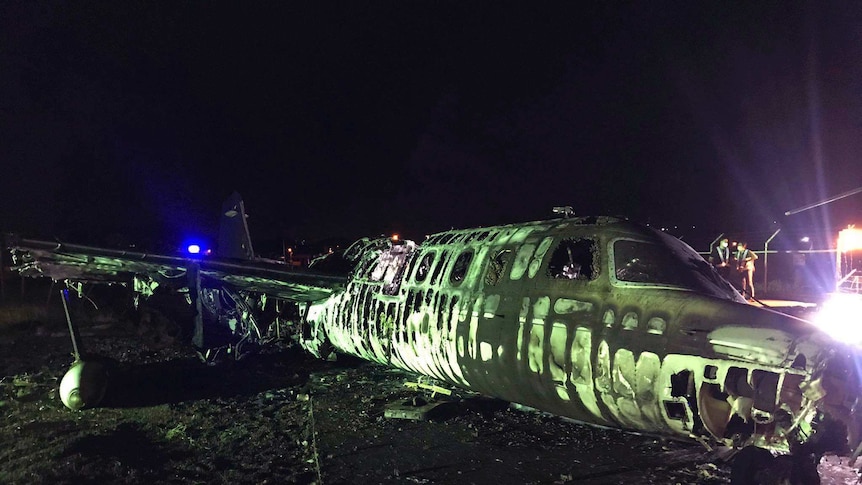 the remains of a Lion Air, West Wind 24 aircraft lies along the runway at Manila International Airport.