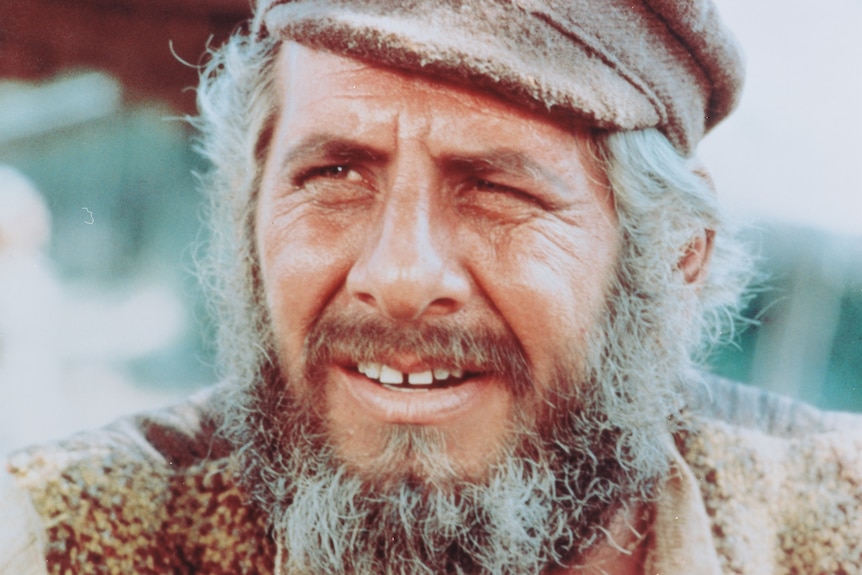 A close-up shot of Topol in Fiddler on the Roof, wearing his peaked cap and iconic grey beard