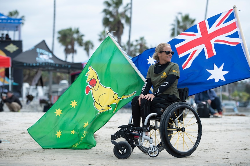 An Australian female surfer with the Boxing Kangaroo and the Australian flags.
