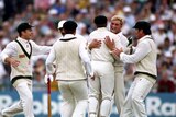 Shane Warne is congratulated by teammates