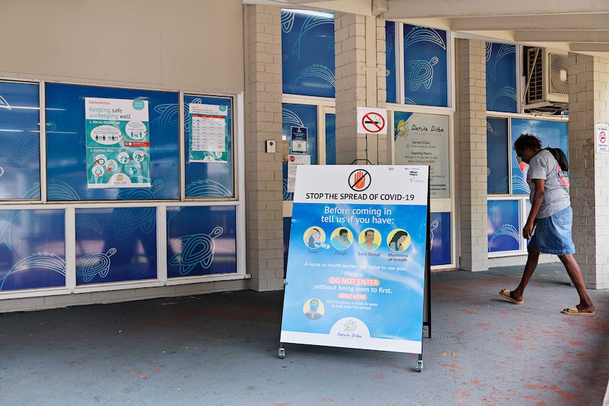 An Indigenous woman walks into the Danila Dilba medical clinic in Darwin.