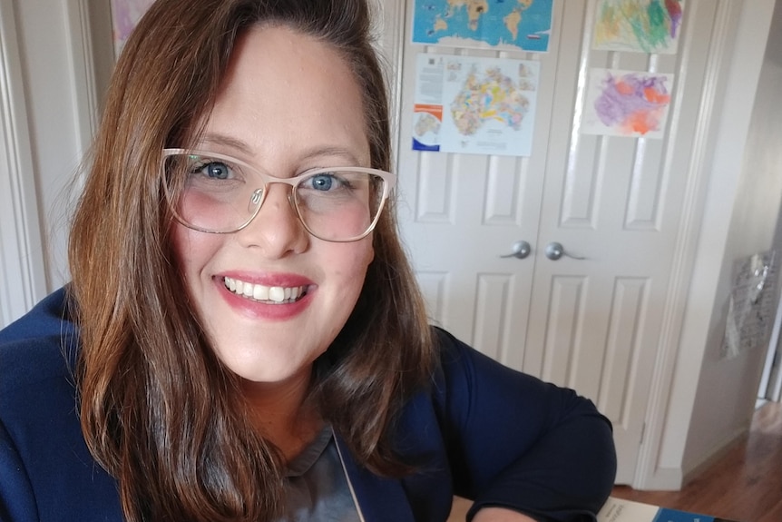 a woman at a computer smiles