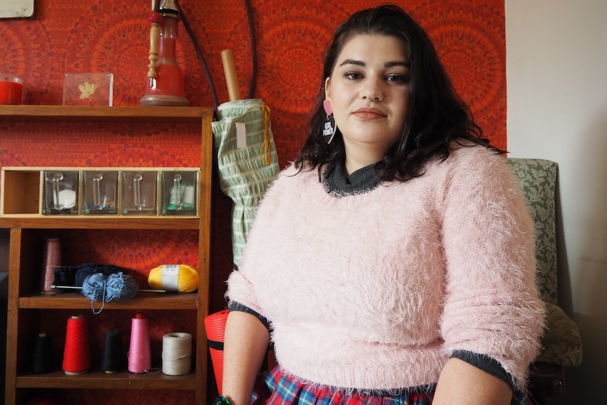 Adelaide renter Shay sits inside a property.