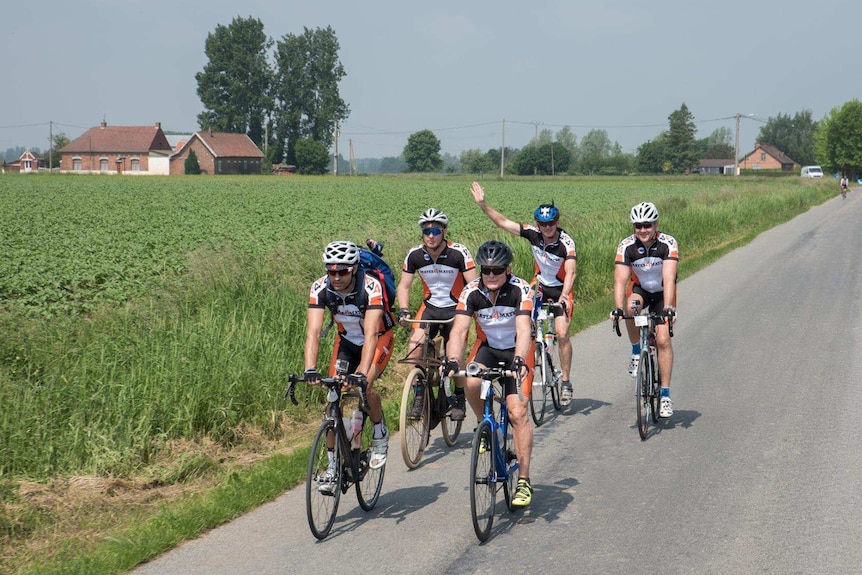 Group of men on bicycles in countryside