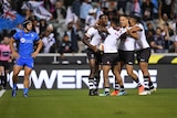 Fiji's Suliasi Vunivalu celebrates with team-mates after scoring a try against Italy