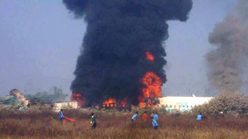 Smoke and flames rise from the Air Bagan plane after it crashed near Heho airport.