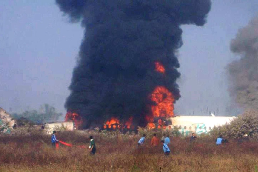 Smoke and flames rise from the Air Bagan plane after it crashed near Heho airport.
