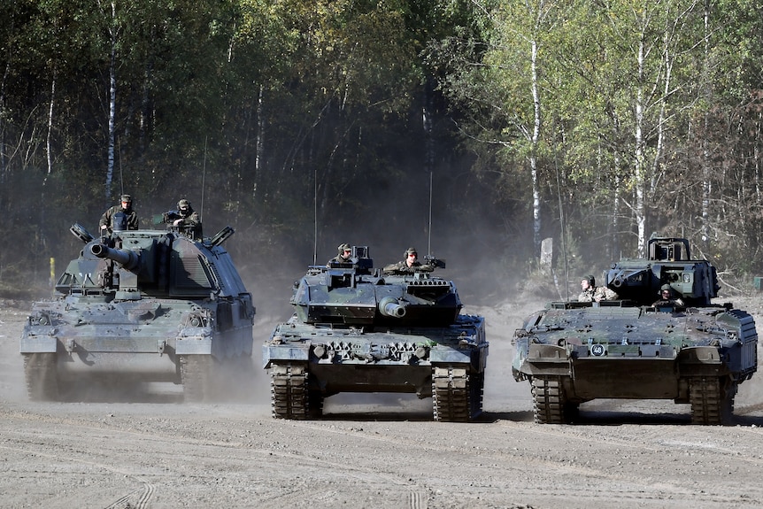Three Leopard tanks.
