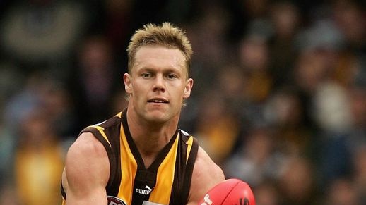 Hawthorn midfielder Sam Mitchell with ball in hand