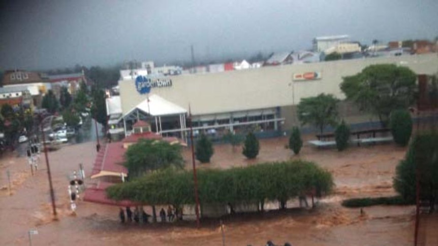 A car floats upside down in flash flooding in Toowoomba