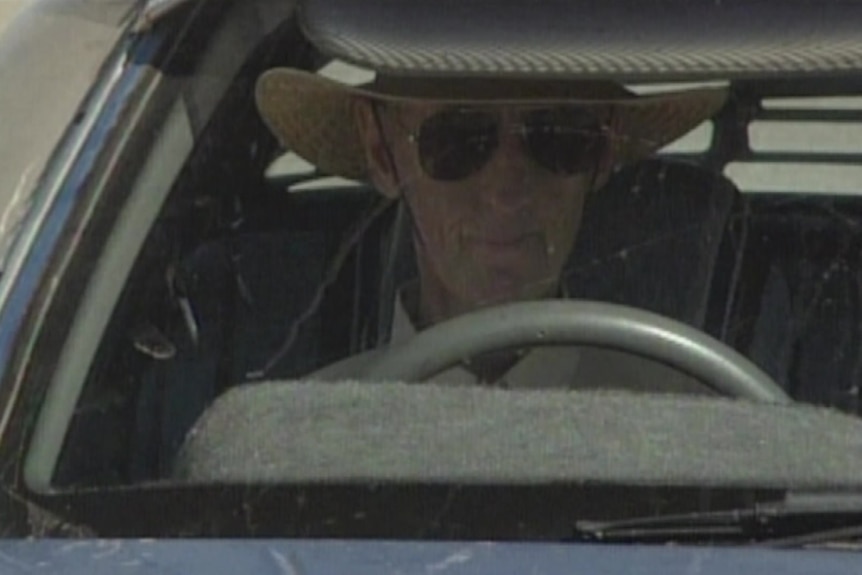 Max Bell inside his taxi wearing sunglasses.