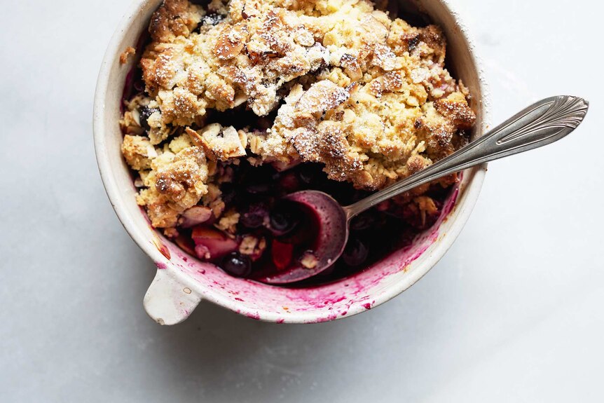 A close up of a pear and blueberry crumble, which makes a perfect for a spring dessert recipe.
