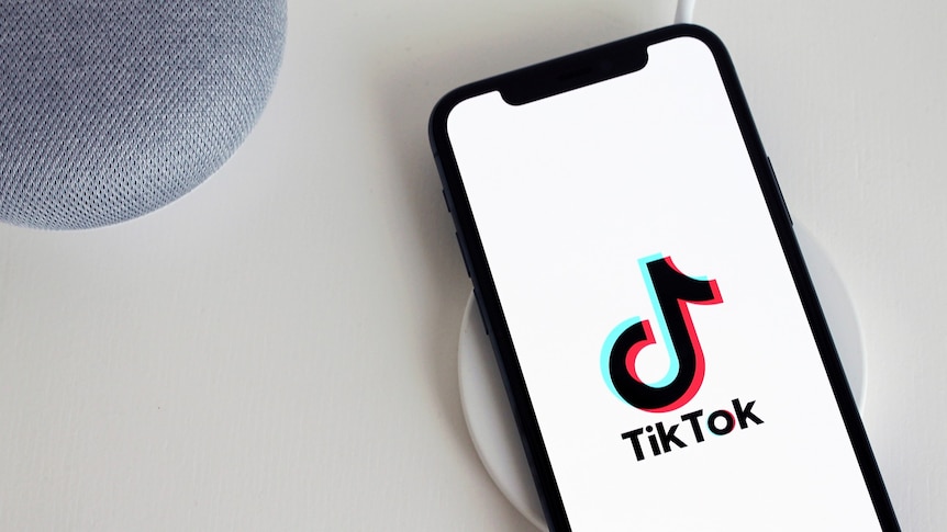 A phone with the TikTok logo displayed.