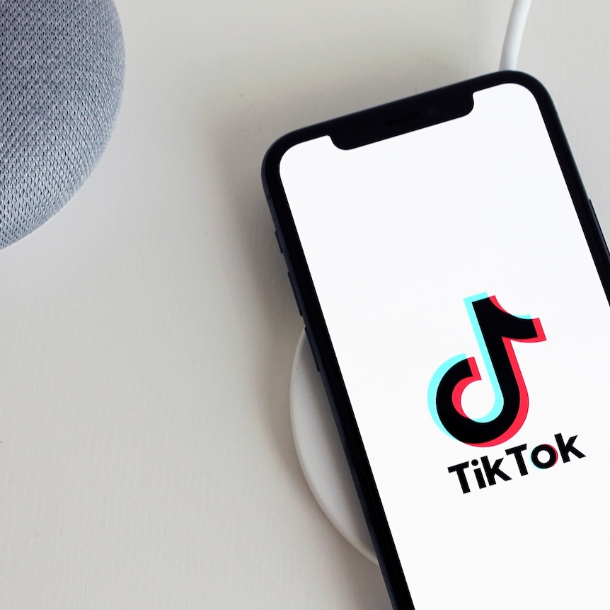 A phone with the TikTok logo displayed.