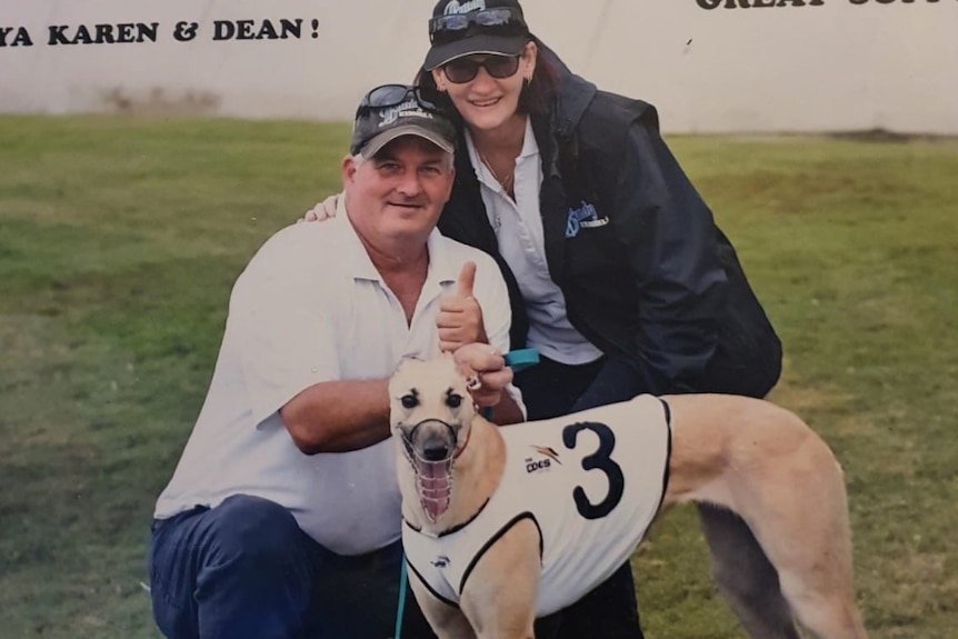 Man and woman with greyhound