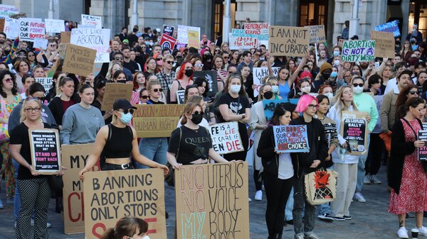 A crowd of protesters holding up various signs