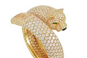 A gold and diamond ring shaped like a big cat.