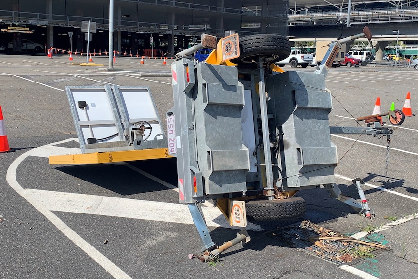 A trailer on its side in a car park at Brisbane Airport