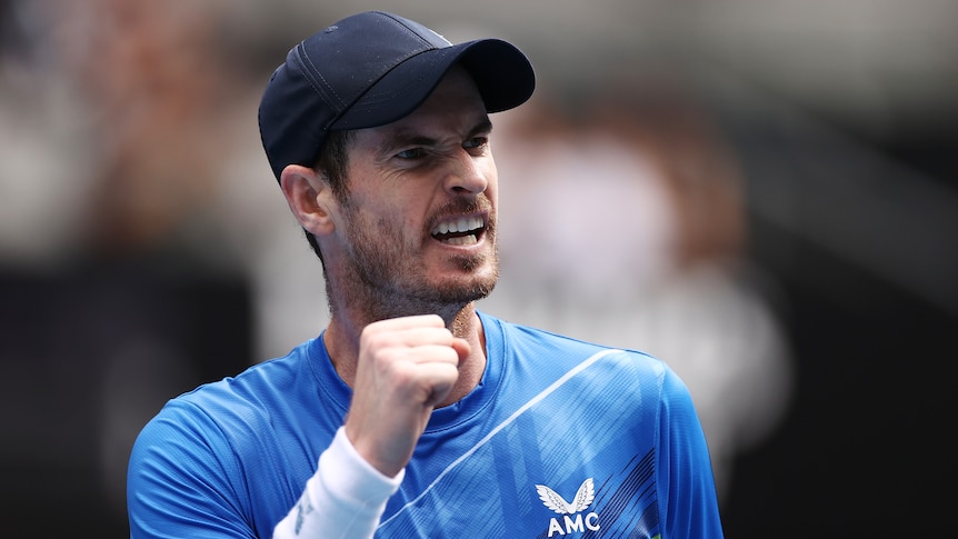A British male tennis player pumps his fist as he celebrates winning a point.