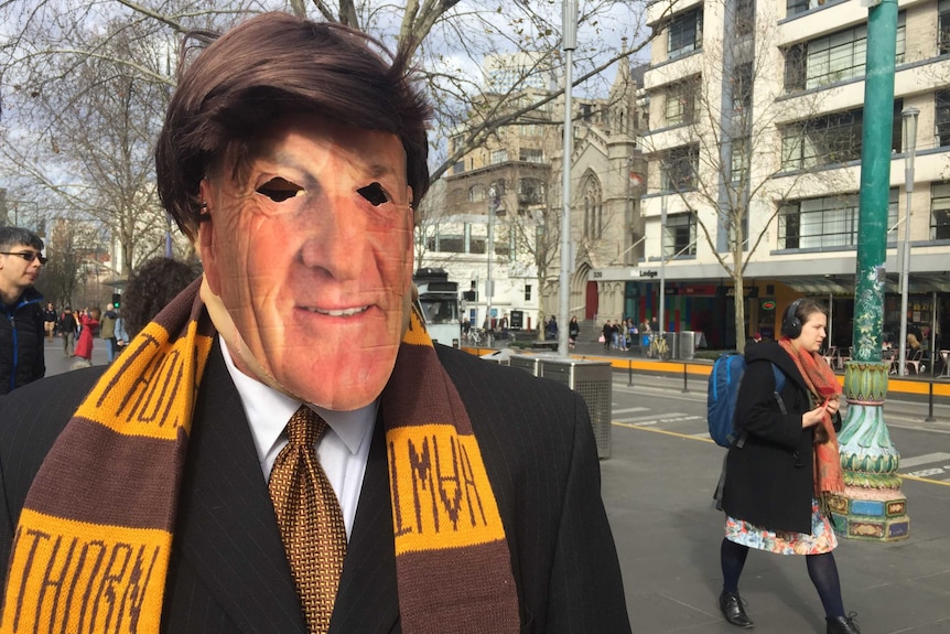A union volunteer dressed as Jeff Kennett outside the Victorian State Library.
