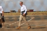 WA premier Mark McGowan walks across airport tarmac. 